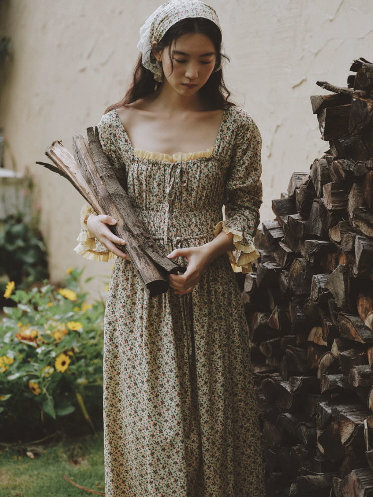 Long floral cotton nightgown with square neckline and cream ruffle trim styled in a rustic cottage setting