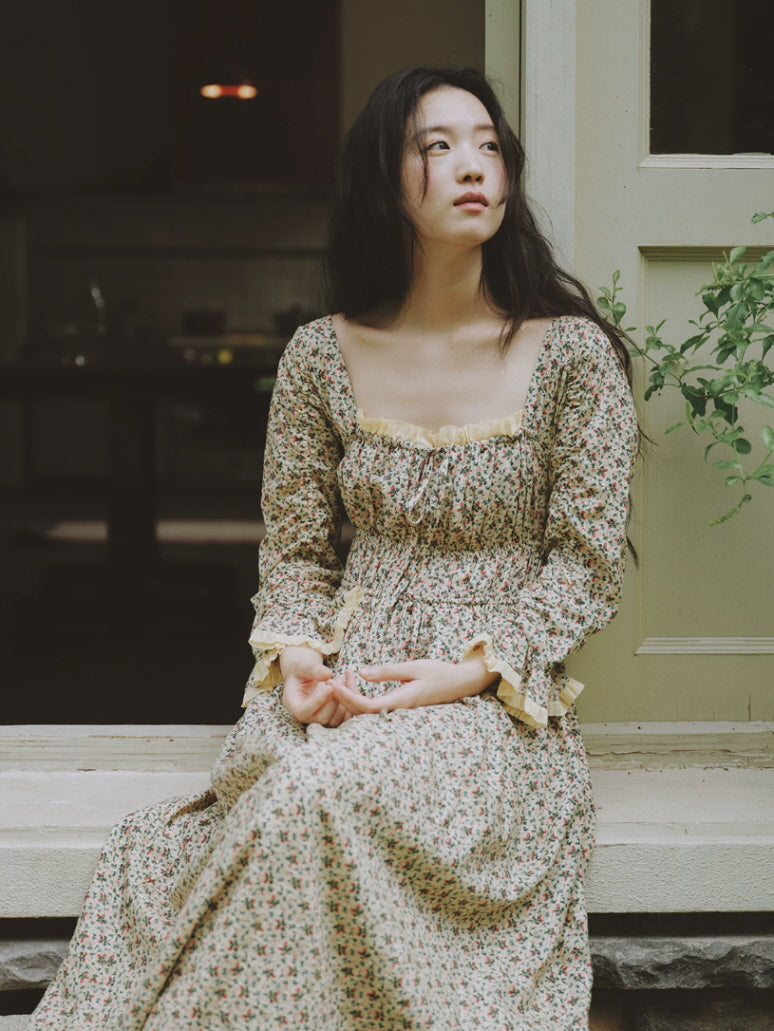 Antique inspired cotton floral nightgown with square neckline and ruffle trim in a cottage garden setting