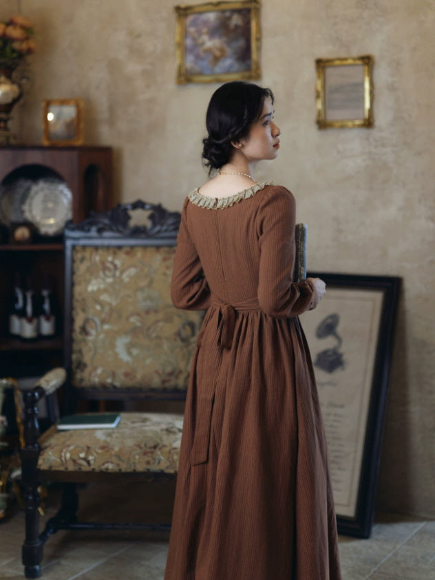 Back view of brown cottagecore maxi dress with waist tie and lace trimmed neckline