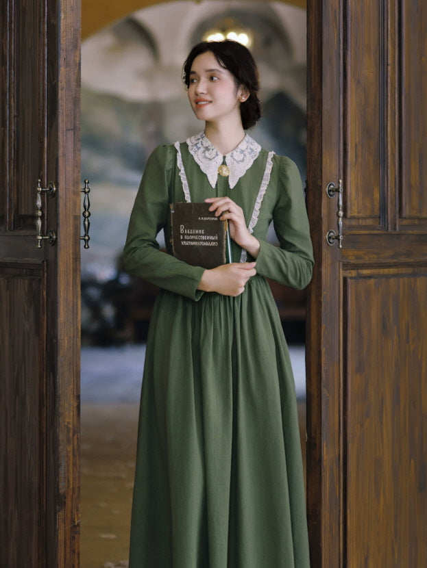 Women’s green cottagecore maxi dress with white lace collar, long sleeves and fitted vintage-inspired bodice
