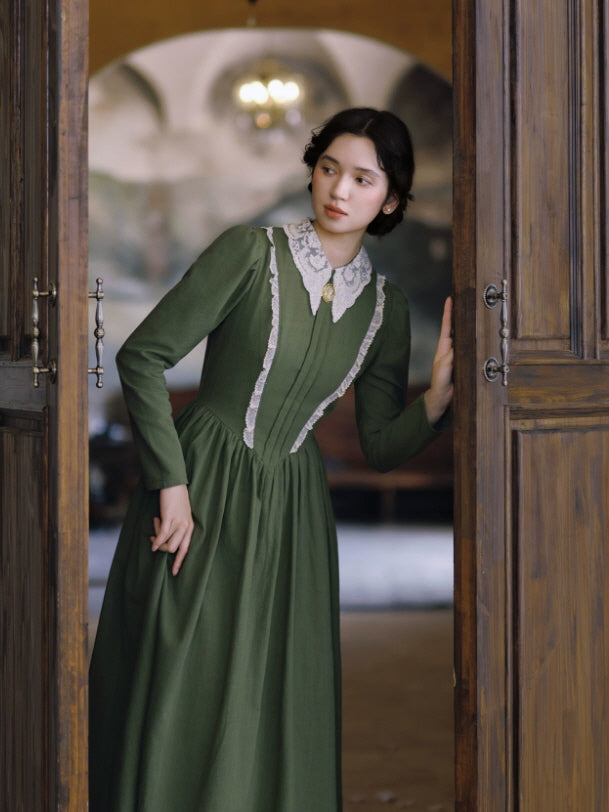 Romantic green prairie dress with lace collar and long flowing skirt styled in a vintage doorway