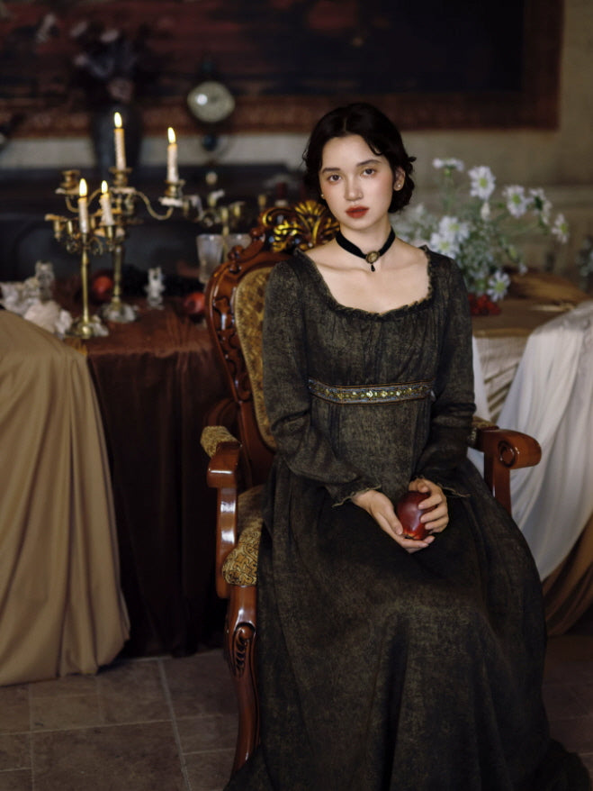 Dark cottagecore maxi dress with long sleeves and empire waist styled in an antique dining room