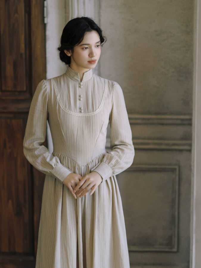Ivory vintage-inspired dress with lace-trimmed bodice, high neckline and elegant long sleeves