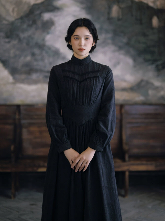 Black long sleeve maxi dress with fitted waist and romantic vintage-inspired silhouette