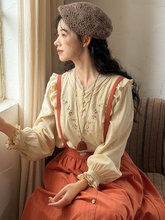 Romantic rust suspender maxi skirt paired with an embroidered ivory blouse and cottagecore accessories