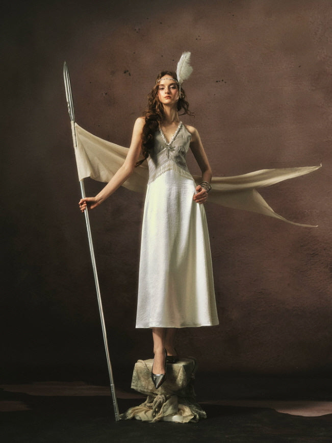 Elegant Gatsby inspired satin maxi dress with intricate pearl detailing, vintage glamour styling, and a flowing ivory skirt.