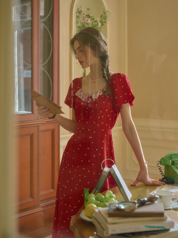 A romantic red dress with lace neckline styled in a vintage room, evoking retro charm and a casual summer vibe.