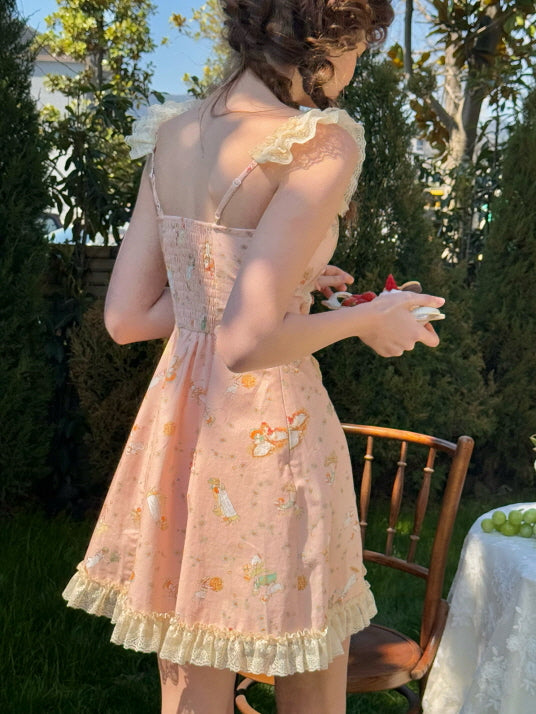 Back view of a fairytale-inspired pink dress with lace ruffle straps and charming floral prints, creating a dreamy cottagecore look in a garden setting.