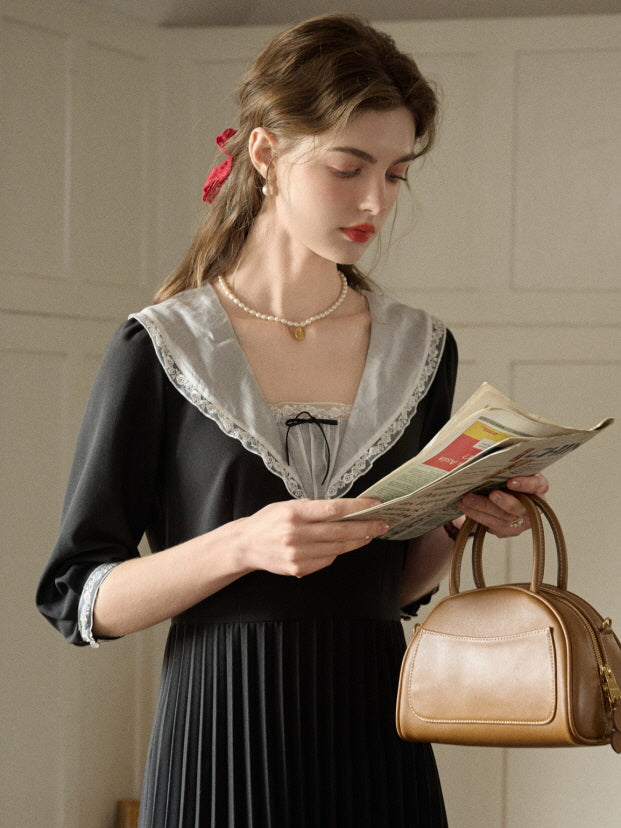 A dreamy retro outfit featuring a black dress with delicate lace details and a pleated skirt, creating a beautiful and casual fairytale-inspired moment.