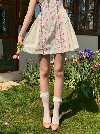 Coquette floral mini dress with lace and ribbon details, paired with lace socks and pastel heels. Feminine, vintage-inspired summer outfit, evoking sweet, romantic garden vibes.