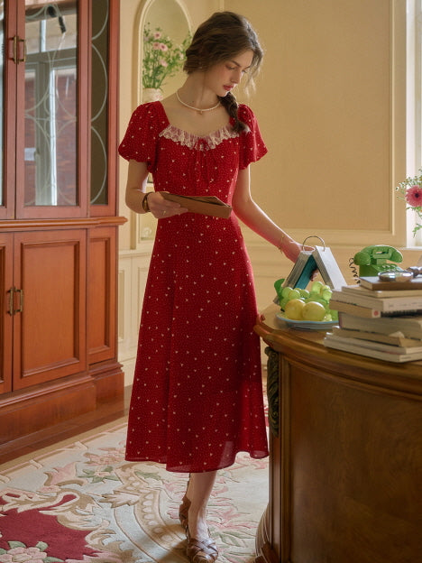 A full-length red retro dress styled with a book and vintage desk setup, highlighting an elegant and aesthetic look.