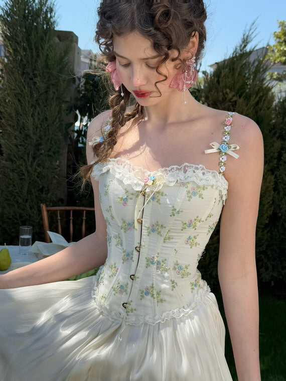 Close-up of vintage floral embroidered corset with lace trim and delicate rose straps, paired with a flowing satin skirt – romantic fairytale outfit for spring