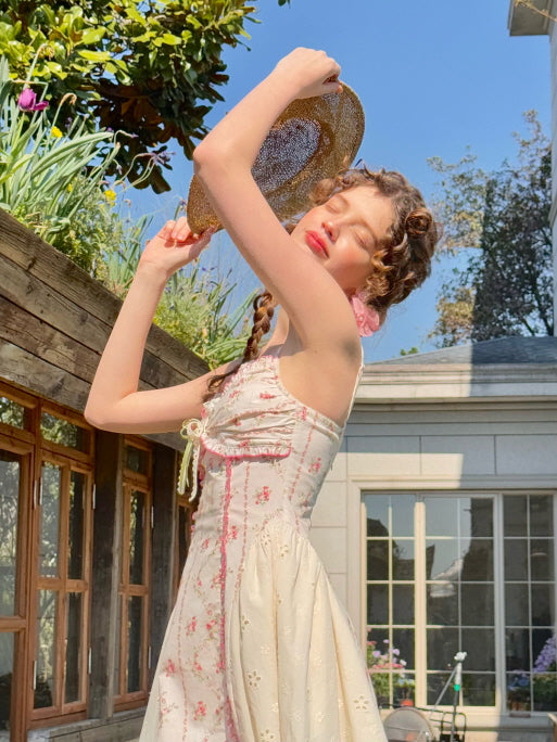 Romantic coquette floral dress with lace trim and bow detail, styled with a straw hat and vintage earrings. Dreamy summer look, capturing a soft, feminine aesthetic perfect for fairytale-inspired moments.