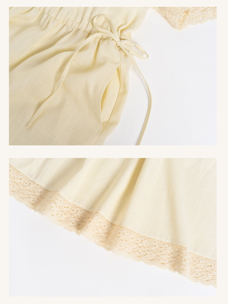 Elegant cream dress with adjustable waist tie and scalloped lace trim hem for a romantic retro aesthetic.