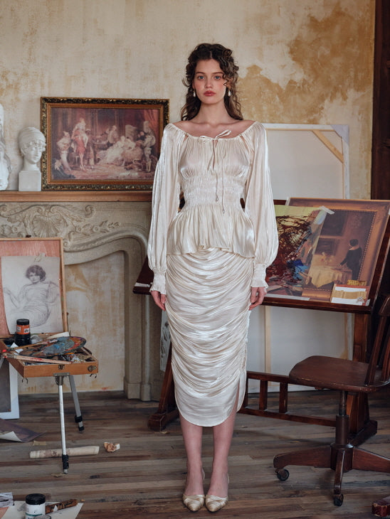 Romantic cream ruched satin skirt paired with glossy ruched blouse, photographed in a classic art studio filled with antique decor – elegant vintage fashion for women
