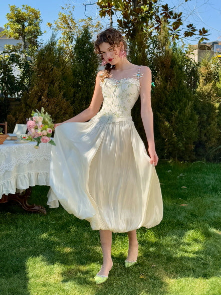 Romantic balloon-style cream skirt with elegant shine, styled for a spring garden look with floral corset top – feminine fairytale aesthetic fashion for women