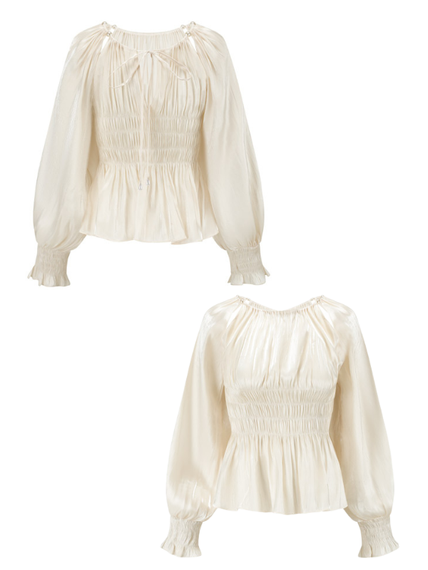Front and back views of an ivory puff-sleeve blouse with a ruched bodice and flared hem, styled with pearl-accented tie neckline, photographed on a white background for an elegant, vintage-inspired look.