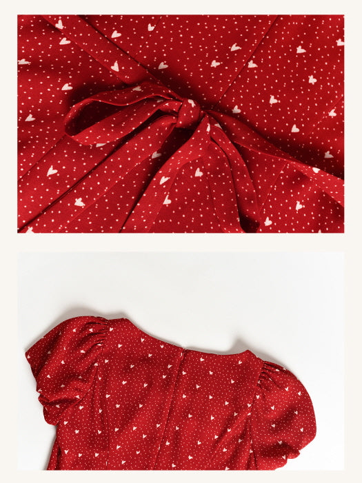 Back details of the red retro dress showing the adjustable waist tie and puff sleeve construction, highlighting vintage-inspired craftsmanship.