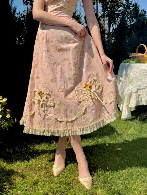 Close-up of a vintage-style floral dress with lace bow accents and ruffled hem, exuding a fairytale-inspired charm in a sunlit garden setting.