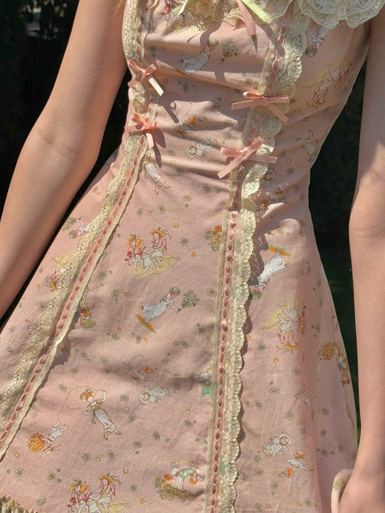 Detailed view of a floral cottagecore dress with lace accents and ribbon bows, featuring a charming fairytale-inspired print in soft pastel hues.