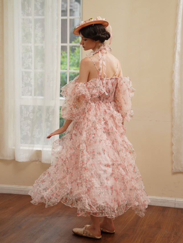 A back view of a romantic layered pink dress with floral print and shirred bodice, flowing gently as the model steps across a sunlit room.