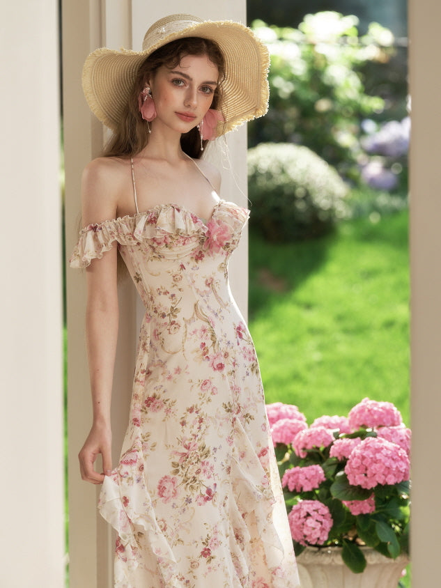 A young woman stands gracefully under the sunlight wearing a floral off-shoulder fairycore dress and a straw hat, exuding fairytale romance.