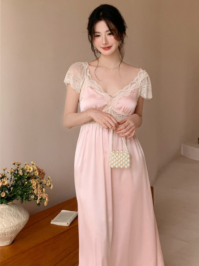 Model standing in a softly lit room wearing a pastel pink lace nightdress with flutter sleeves, styled in a vintage princesscore aesthetic.