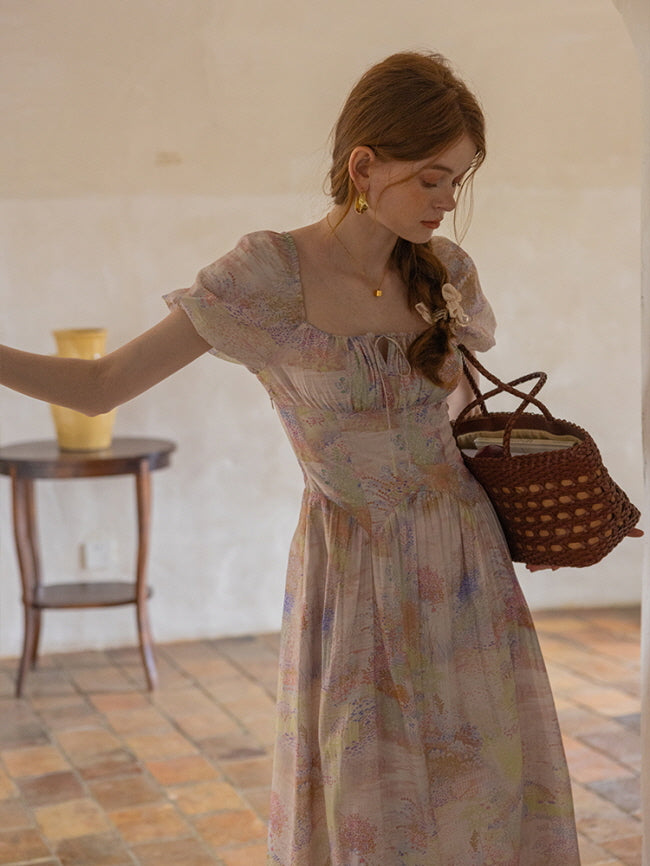A young woman carries a woven bag while wearing a delicate pastel floral dress with puff sleeves, embodying a romantic, fairycore aesthetic.