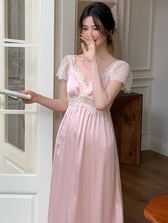 A woman stands by a door in a soft pink lace-trimmed nightdress, smiling sweetly while holding a newspaper, embodying princesscore charm.
