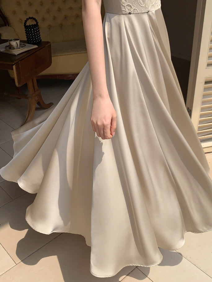Close-up of a flowing cream dress twirling in sunlight, showing delicate floral lace and a dreamy vintage silhouette from Romantic Fairytale.