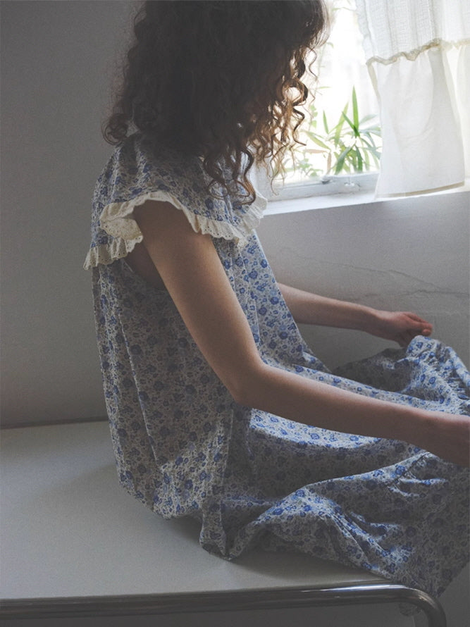 Seated quietly by the window, the model wears a loose vintage-style nightgown with ruffled lace sleeves, evoking a serene fairytale moment.