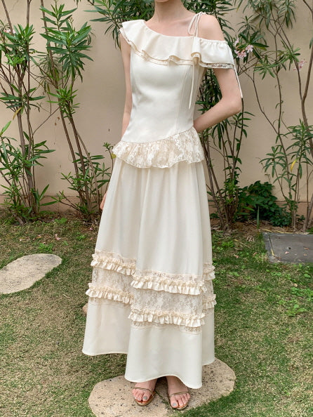 In a soft one-shoulder cream top and ruffled lace skirt, the model stands gracefully in a garden, evoking a dreamy princesscore silhouette.