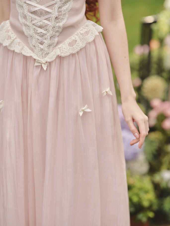 A close-up of the lace-up waist and delicate ribbon details on a pastel pink corset fairytale dress, perfect for a romantic fairycore outfit.