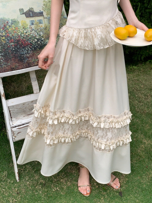 Close-up of a cream skirt with layered lace and ruffles, styled with sandals and lemons in hand, capturing vintage and fairycore elegance.