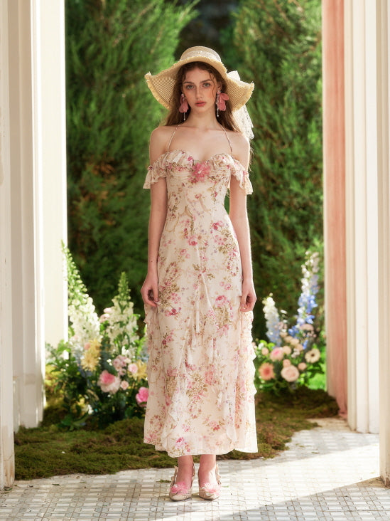 Framed by garden blooms, the model poses in a romantic floral dress with ruffle details, embodying a vintage princesscore daydream.