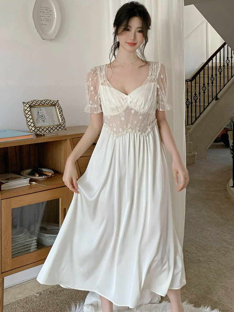 Woman standing in a fairytale-inspired nightdress with a mesh floral bodice and flowing skirt, styled in a dreamy cottagecore interior.