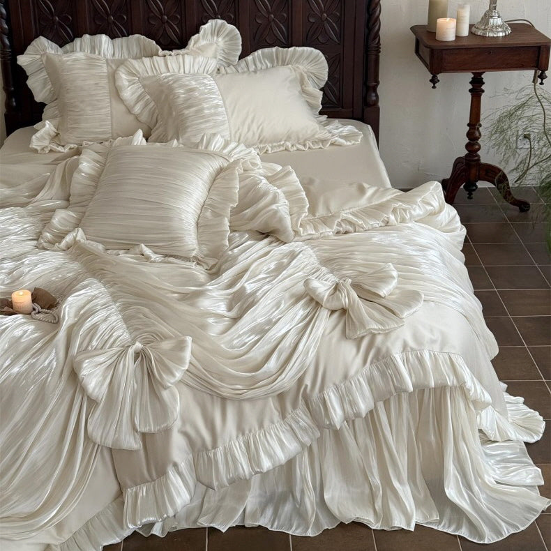 Ivory ruffled bedding set arranged on a classic wooden bed, creating a soft fairytale and vintage bedroom atmosphere.