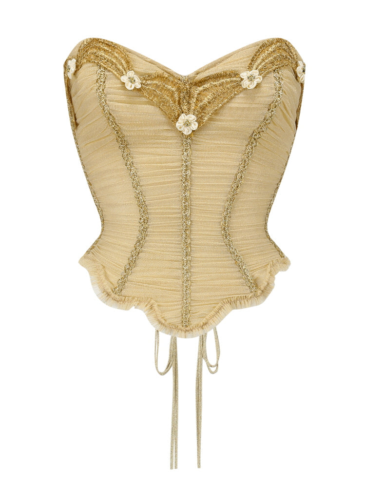 Product photo of a vintage-inspired gold corset with floral trim and lace-up detail, featuring a sweetheart neckline and scalloped hem, ideal for romantic fairytale looks.