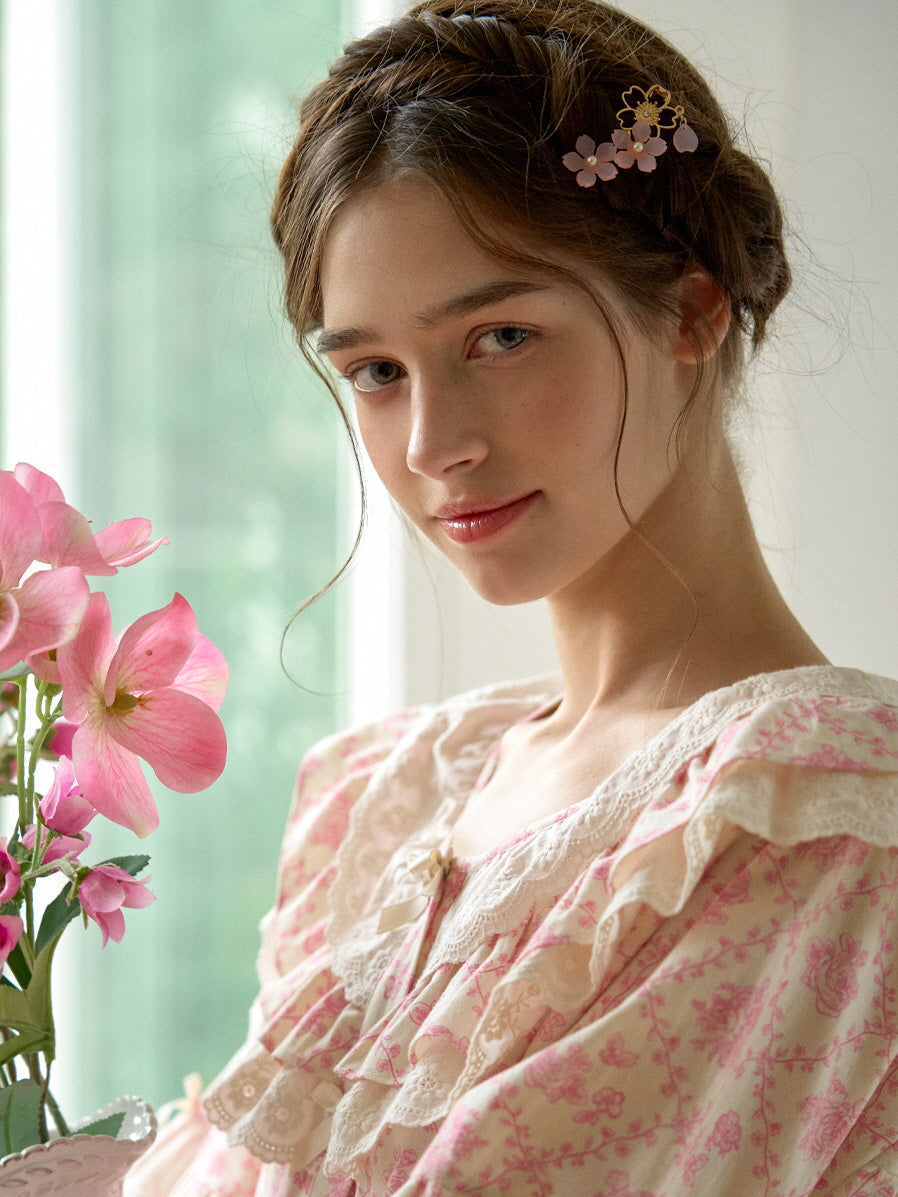 A soft, romantic look featuring a model in a pink floral nightgown with lace ruffles, styled with a floral hairpin for a cottagecore aesthetic.