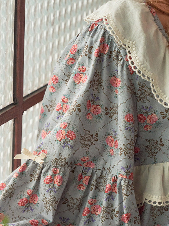 A close-up of the puff sleeves of a blue floral nightgown, showcasing delicate lace trim and bow accents for a soft, romantic aesthetic.