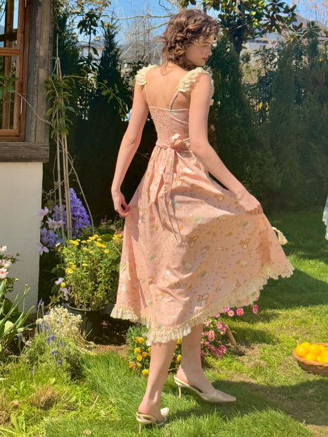 Back view of a romantic cottagecore-style dress adorned with floral lace and bow accents, flowing gracefully in a flower-filled garden.