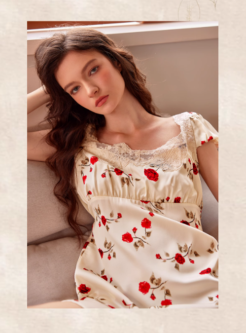 The model leans against a cushion in a cream rose-print nightdress with lace trim, exuding a soft and romantic princesscore elegance.