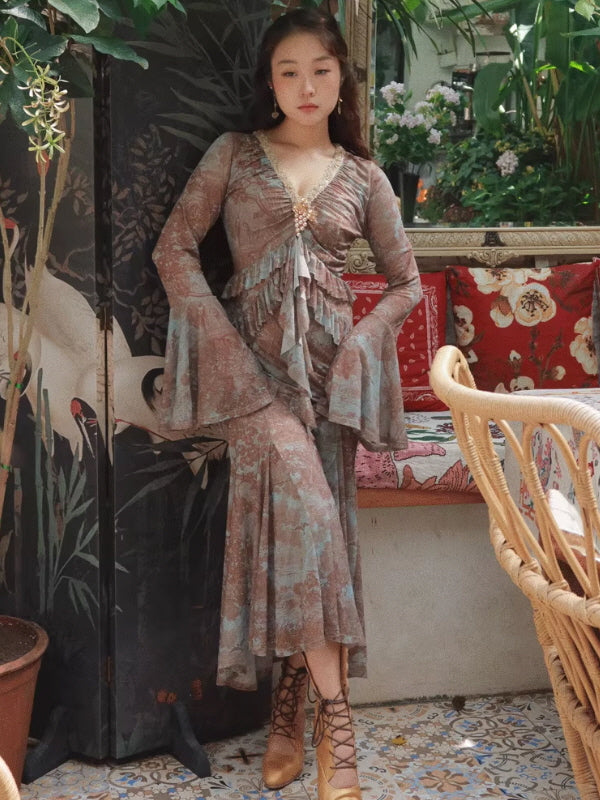 Full-body view of a Romantic Fairytale vintage-inspired floral maxi dress with lace V-neck, layered ruffle bodice, sheer bell sleeves, and flowing hem, styled indoors for a cottagecore fairycore vintage look.