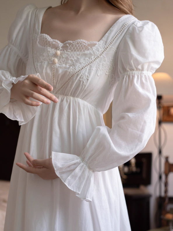 Close-up of ivory square neckline nightgown with lace trim, floral embroidery and covered buttons, vintage-inspired cottagecore loungewear detail shot.