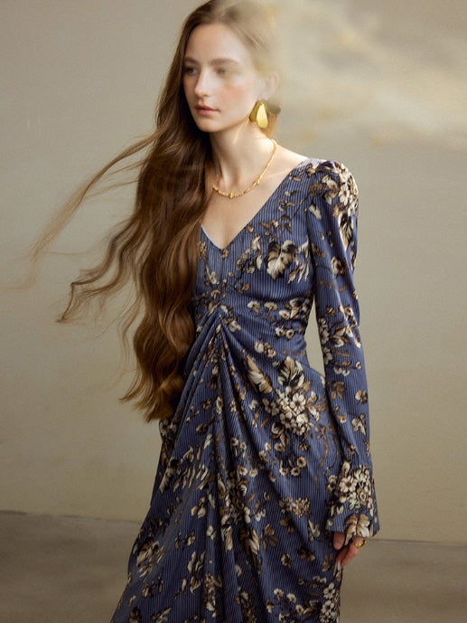 Close-up of navy floral long sleeve dress with V neckline and draped ruched waist, vintage cottagecore aesthetic outfit with soft puff shoulders.