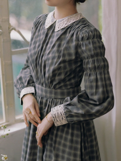 Close-up of grey check vintage dress with lace collar and lace cuffs, showing pleated bodice and classic cottagecore details in soft natural light.