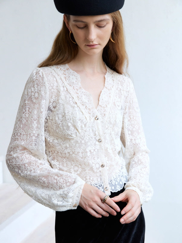 A vintage-inspired ivory lace blouse with scalloped neckline and floral details, styled in a romantic cottagecore outfit.