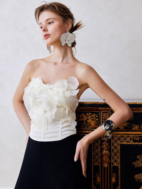 Romantic strapless floral corset top with layered chiffon petals and pearl details, styled with black trousers for a vintage fairycore aesthetic outfit.