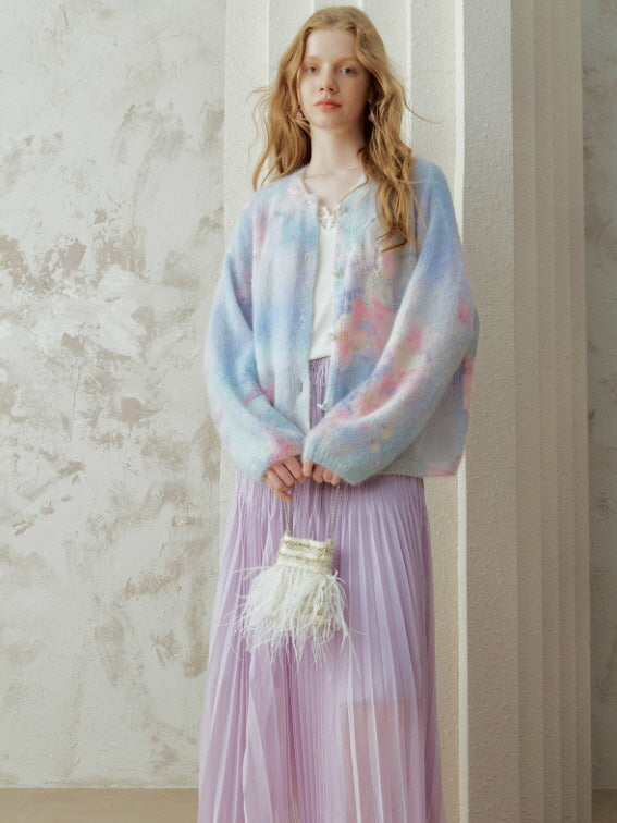 Vintage-inspired pastel knit cardigan layered over a flowing pleated skirt, creating a dreamy cottagecore outfit with soft colors and an elegant fairytale mood.