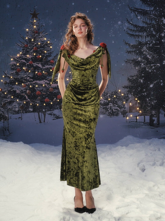 A romantic olive velvet dress with a softly draped neckline and rose shoulder details, photographed in a snowy winter fairytale setting, featuring a vintage silhouette and elegant feminine mood.